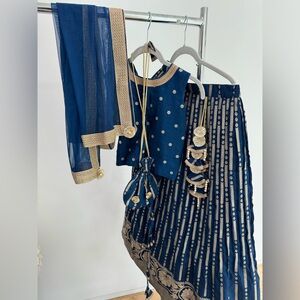 Floral Embroidered Blue Top And Lehenga With Matching Net Dupatta And Potli Bag